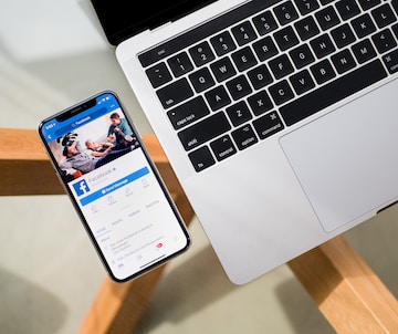 iPhone X beside MacBook